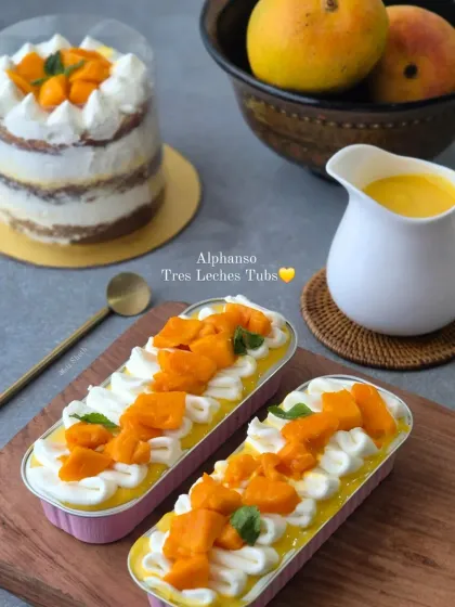 I offer a variety of mini fresh Alphonso desserts. This includes my popular Tres Leches tubs and a semi-naked mini cake, all bursting with real mango flavor.