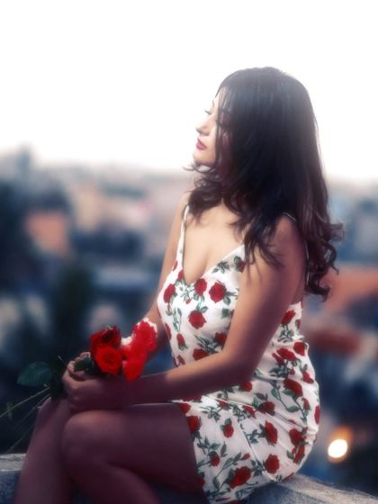 Looking out at the city, lost in thought. This portrait captures a moment of quiet contemplation, with the soft focus creating a dreamlike atmosphere.