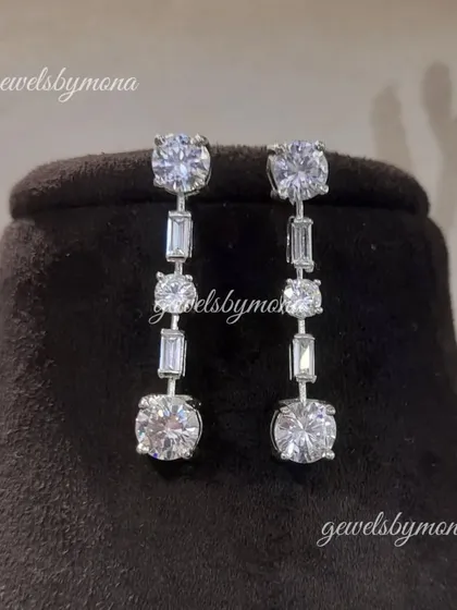 Simple yet stunning diamond drop earrings. These earrings feature a line of brilliant-cut diamonds, making them the perfect accessory to complement a statement necklace or to be worn on their own for a touch of elegance.