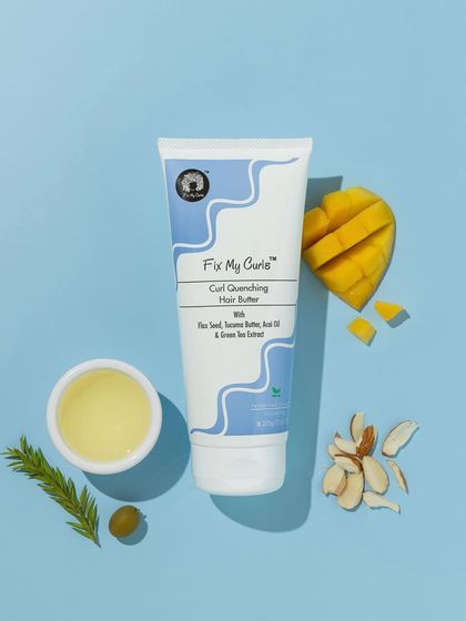 This vibrant, color-coordinated flatlay uses a bright blue background to make the natural ingredients pop. The composition with mango, almonds, and olive oil is fresh, tropical, and appealing.