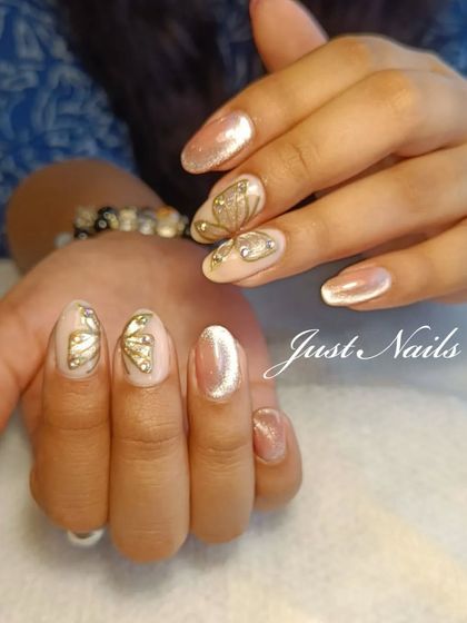 A delicate and whimsical design featuring a shimmery nude base with hand-painted gold butterfly wings and rhinestone accents.