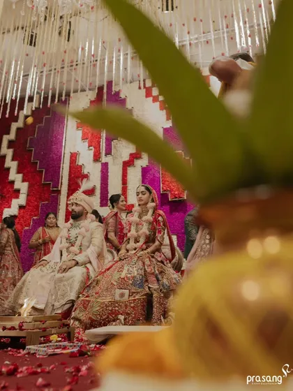 An artistic shot of the ceremony, framed by a traditional kalash. I work with photographers to find unique perspectives that tell the story of the wedding with creative depth.