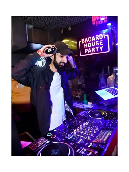 Getting the next track ready. A DJ's work is a constant process of selection, mixing, and reading the energy of the room.