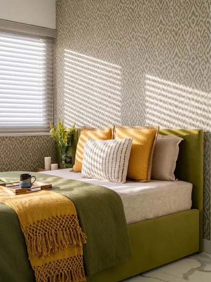 For this vacation penthouse sunroom, we blended traditional Indian motifs with a fresh, modern palette. The Ikkat print wallpaper and citric green bed upholstery create a vibrant, sun-drenched space that feels both traditional and contemporary.