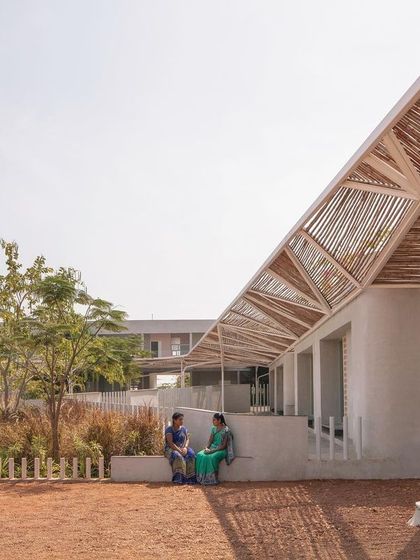 (Duplicate of 44) The simple, light-colored plaster walls provide a neutral backdrop to the vibrant life of the school and the rich textures of the landscape and bamboo canopy.