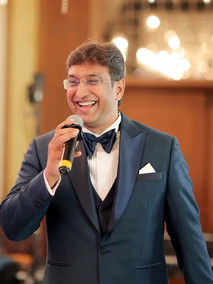 The joy of celebration is amplified when you feel your best. Mr. Jayesh, in his bespoke deep blue tuxedo, is the picture of happiness and confidence, ready to be the life of the party.