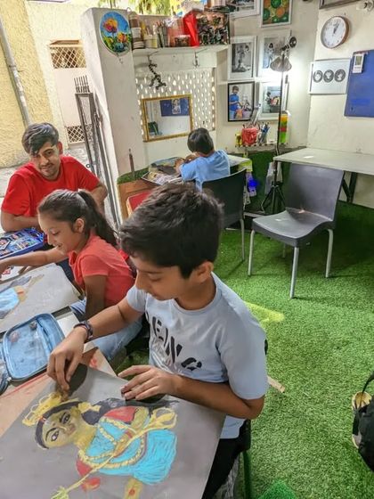 Another view of our busy and creative classroom, with students of all ages engrossed in their artwork.