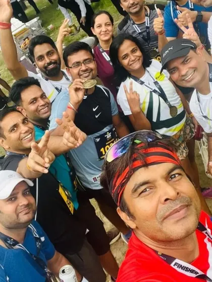 A large group selfie of happy runners after the Farmley Snack Run. The smiles and medals say it all.