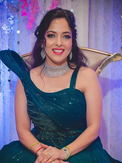 Our beautiful engagement bride Shraddha, looking radiant in her teal gown. The makeup features a soft smokey eye and a bright smile, ready for her celebration.