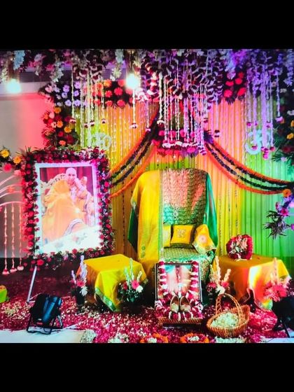 For this Guruji Satsang, the theme was yellow and green. I used drapes and marigold garlands to create a bright backdrop, with a dense floral canopy overhead and spotlights to highlight the Aasan.