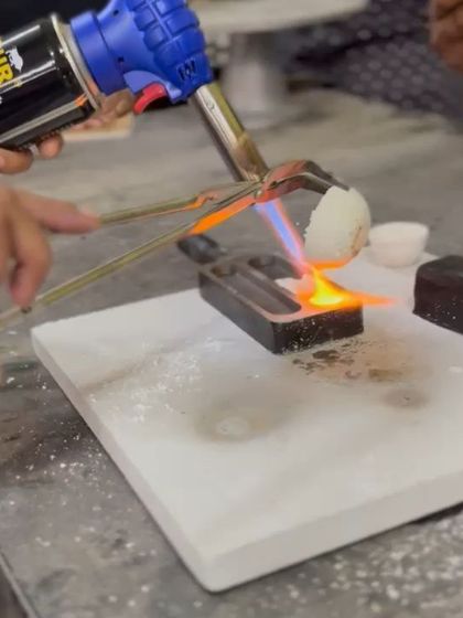 The very first step: melting raw silver granules in a crucible with a blowtorch. This is where the transformation from material to art begins.