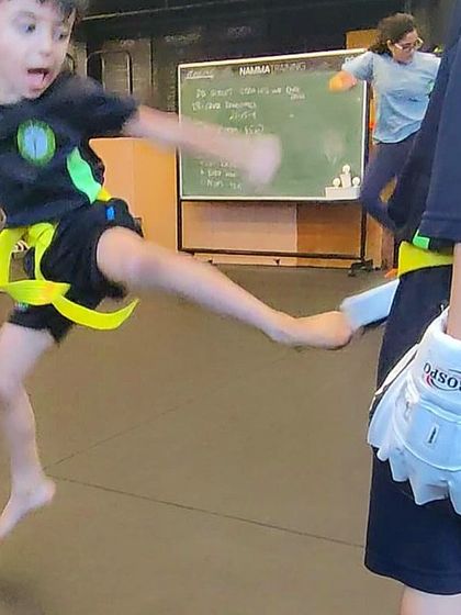 Look at those Kikkers fly. A student executes a powerful flying side kick, capturing the energy and skill we build in our classes.