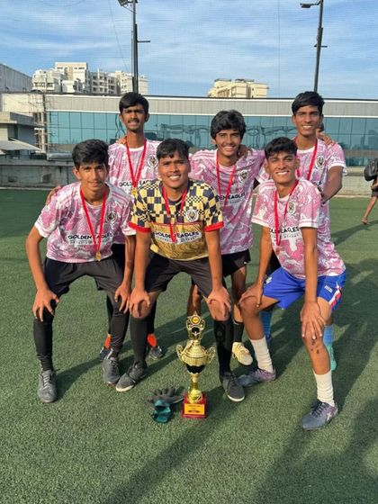 The full U18 squad with their trophy. Team photos like this capture the camaraderie and shared joy of victory that we foster in our academy.