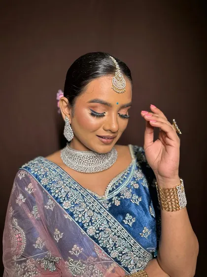 A soft, demure pose showing the beautiful eyeshadow work.