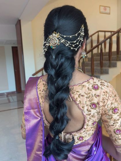Another view of the traditional braid with hair jewellery, showing how it complements the embroidered blouse.