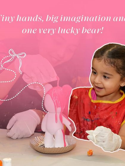 A little girl is delighted as she pours pink paint over a bear figurine. This bear-painting activity is a fun, sensory experience that kids absolutely love.