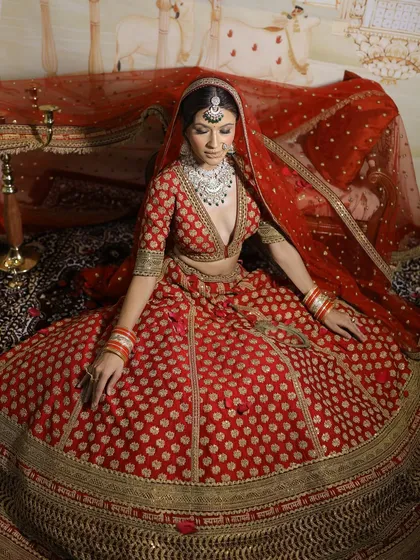 Another angle of this majestic bridal look, showcasing the flow of the lehenga and the way the makeup holds up, looking fresh and radiant.