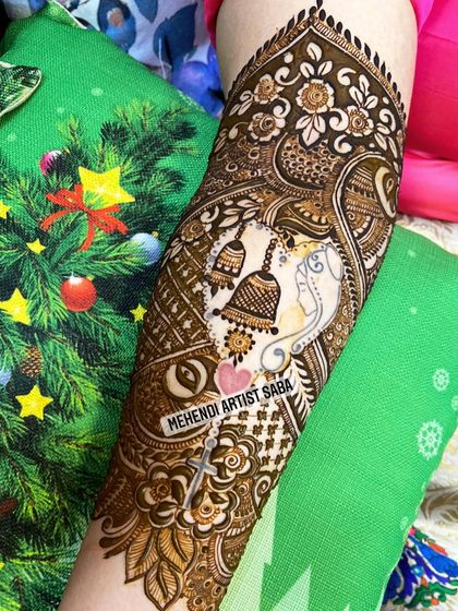 A clearer view of the Ganesha and temple bell design, showing the intricate details and the hidden initial "S".