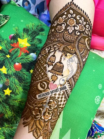 A slightly different angle of the Ganesha and temple bell design, showing the fine details and shading.