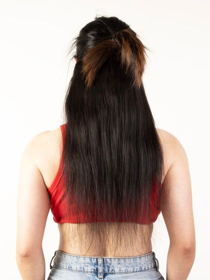 A close-up back view of a model's hair with extensions, showing the layers.