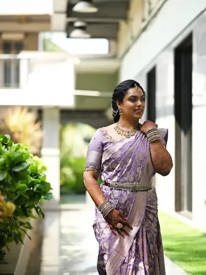A graceful walking shot, showing the beautiful drape of the Kanjeevaram saree and the elegant hairstyle.