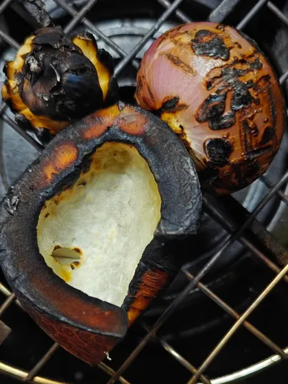 The secret to my Chicken Kale Sukka is charring the ingredients. Dry coconut, onion, and garlic are roasted over an open flame to add a beautiful smoky depth to the dish.