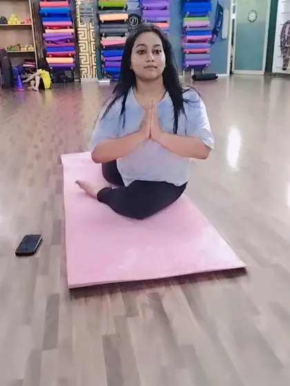 A student holding the pigeon pose, a fantastic hip opener that prepares the body for more advanced seated postures and backbends.