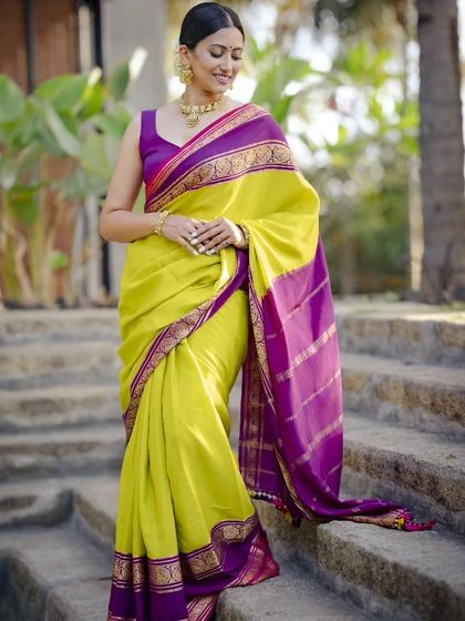 The elegant drape of the pure Mysore crepe saree is highlighted in this beautiful outdoor shot. The color combination is perfect for both day and evening events.