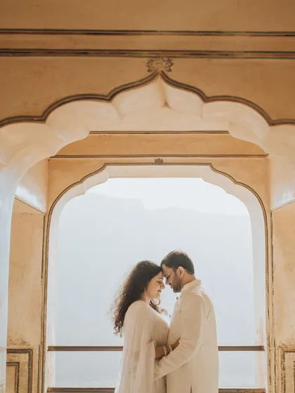 Framed by the beautiful arches of a Rajasthani palace, this couple shares a quiet, intimate moment. We use architectural elements to create naturally beautiful compositions that highlight your connection.