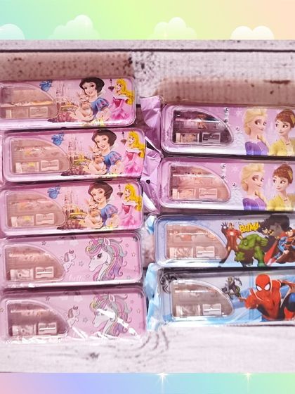 A variety of themed pencil cases that can be included in the rainbow hampers, with designs like princesses, unicorns, and superheroes.