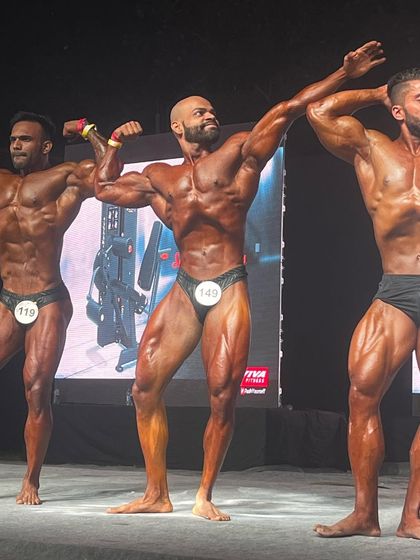 A classic pose on stage. This is what a winning classic physique looks like. It's about aesthetics, symmetry, and conditioning.