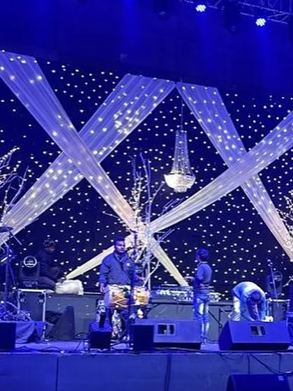 The band sets up on the starry night themed stage, giving a behind-the-scenes glimpse of the preparation that goes into creating a flawless night of entertainment.