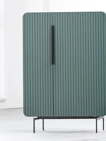 The same fluted cabinet design in a dusty sage green, showcasing its versatility and retro-inspired lines.