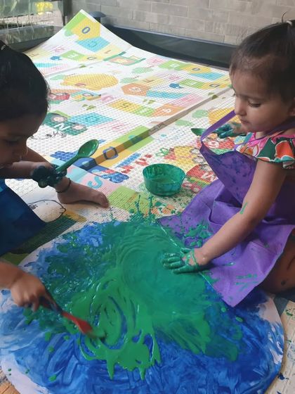 Celebrating our planet during Earth Day with some big, messy, hands-on painting. These two are working together to paint a giant Earth, learning about continents and oceans.