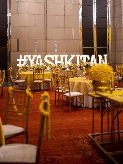 The seating area for the Genda-themed Haldi, with the couple's hashtag taking center stage.