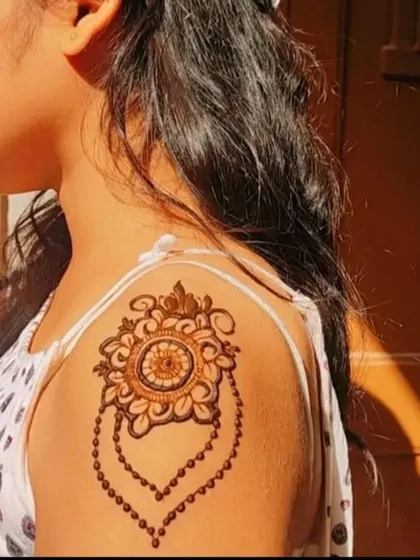 A beautiful jewelry-inspired mandala design placed on the shoulder.