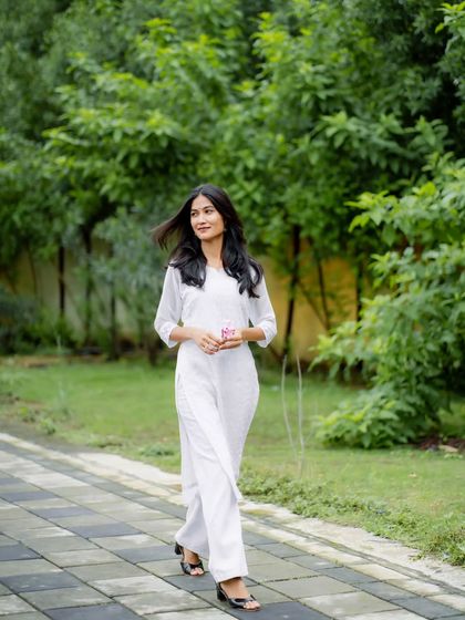 A full-length walking shot that shows the complete outfit. This type of photo is great for fashion bloggers or brands showcasing their designs.