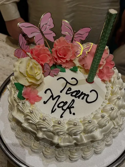 Celebrating my amazing team with a special cake. This design features beautiful floral and butterfly toppers with a sparkling candle. I can create a similar customized cake for your team celebration or any special event for just 1500 rupees per kg.