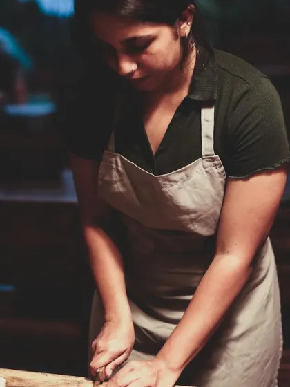 The intense focus of a student mastering her knife skills. We provide a supportive environment to learn and grow as a cook.
