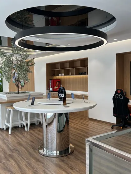 An experience zone we designed for an iQOO and Vivo showroom in Ahmedabad. The space includes a gaming area with specialized chairs and a central display island, creating an interactive environment for customers.