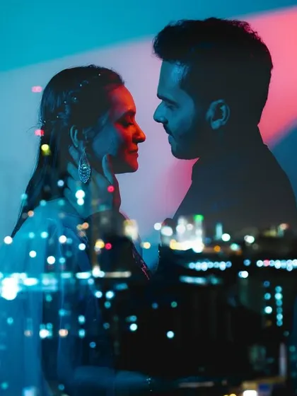 We love playing with light to create a mood. This double exposure shot against a city skyline blends the couple's intimacy with a modern, artistic vibe, perfect for a cocktail night or pre-wedding shoot.
