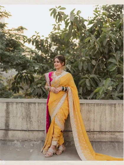 A classic portrait of the bride in her traditional Marathi attire. The soft, natural light and green foliage in the background create a serene and timeless feel for this pre-wedding photograph.