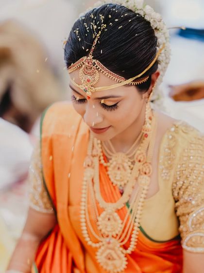 A beautiful portrait of the bride during her wedding ceremony. The soft lighting and her gentle expression create a feeling of peace and sanctity.