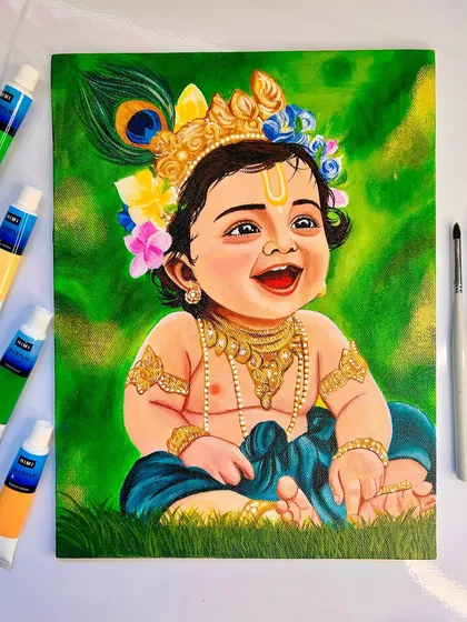 The full Bal Krishna painting, surrounded by the tools of my trade. This piece is filled with vibrant greens and golds, celebrating the playful spirit of Krishna.