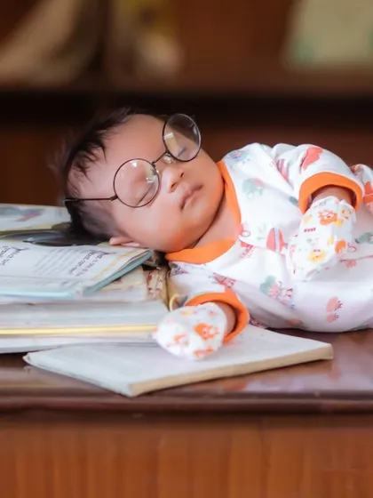 Even the tiniest scholars need a nap. This creative newborn portrait showcases how I use simple, charming props like these glasses to create a unique and memorable image.