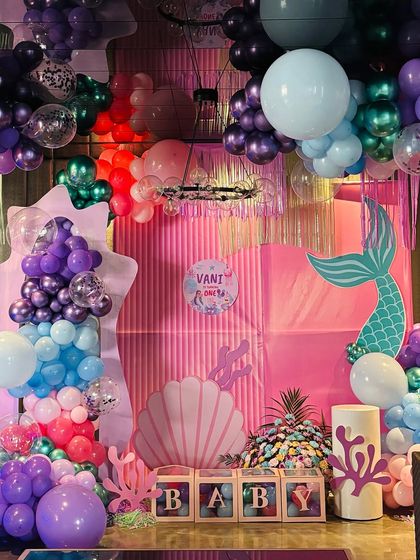 Another angle of the elaborate mermaid theme decor, showing the depth and detail of the balloon structures. We use balloons of various sizes and colors, including confetti and metallic balloons, to create a rich, multi-dimensional look.