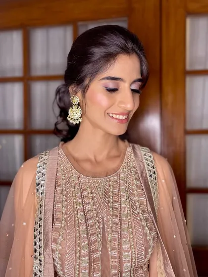 Soft glam goals. A dewy, radiant look with a touch of blush pink eyeshadow and a nude lip, finished with a sleek bun.
