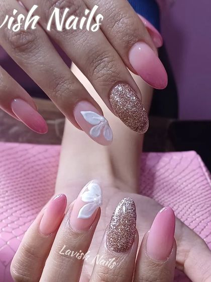 A sweet design combining pink ombre, gold glitter, and a delicate 3D white flower accent.