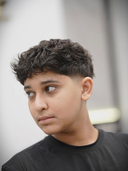 A taper fade on a younger client. This style is cool, modern, and easy to maintain.