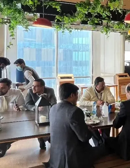 Professionals networking and enjoying a meal at a sit-down corporate event I catered. I create a comfortable and conducive environment for business gatherings.